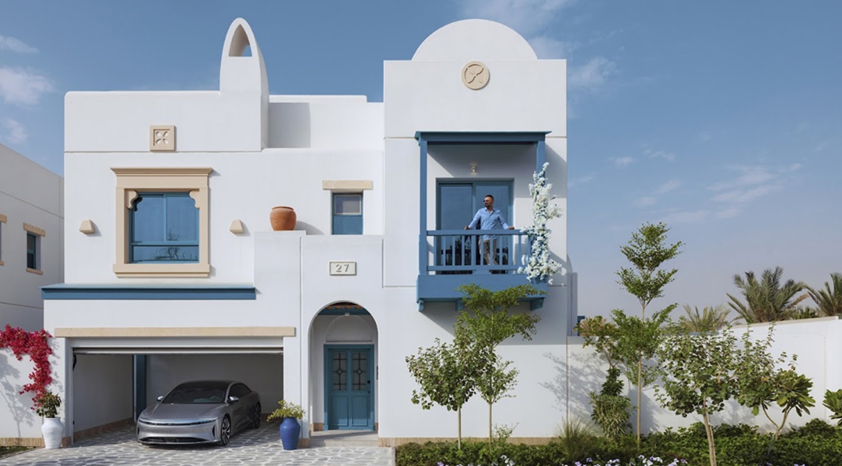 man standing on his villa balcony
